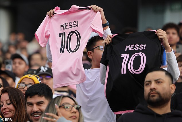 Fans hold up Miami jerseys bearing the name Lionel Messi ahead of Sunday night's match