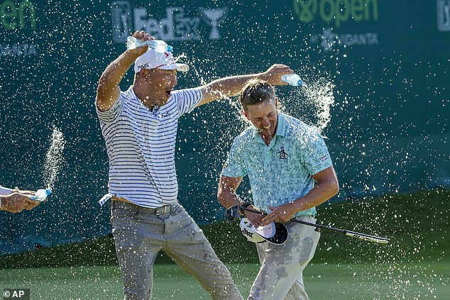 The 29-year-old - a former nightclub bouncer - is doused with water after his victory