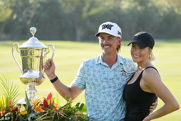 The American rookie poses with the trophy next to his girlfriend Makena White