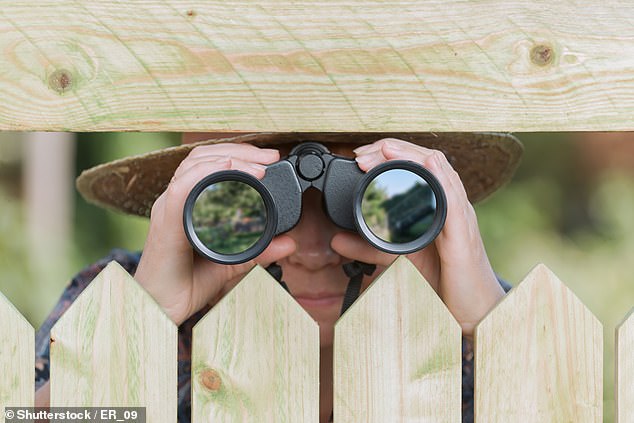 The neighbor spread rumors about the woman after snooping around her house and noticed two men living with her (stock image)