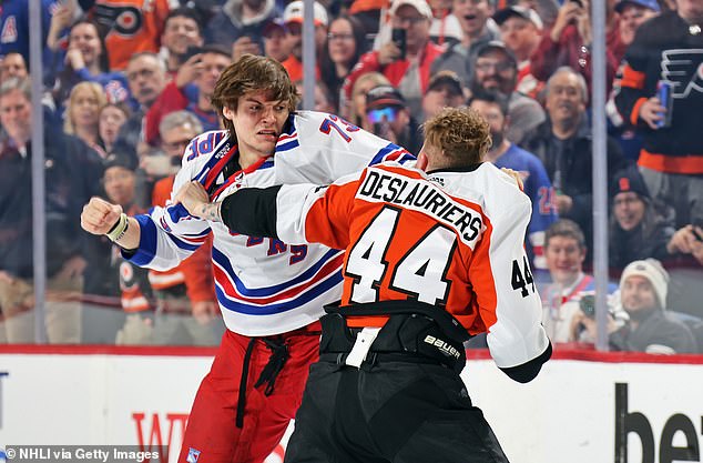 Rempe (in white) is seen with some damage to his face during the brawl with Deslauriers