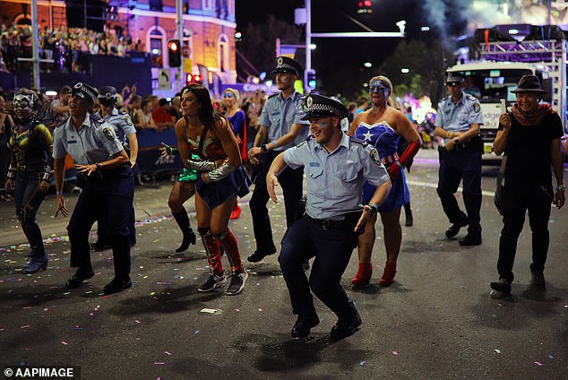 Many Mardi Gras participants have called for the removal of the NSW Police (pictured in the 2019 parade) from the parade, but Commissioner Webb believes the decision will worsen the chronic 'under-reporting of crimes in the queer community'.