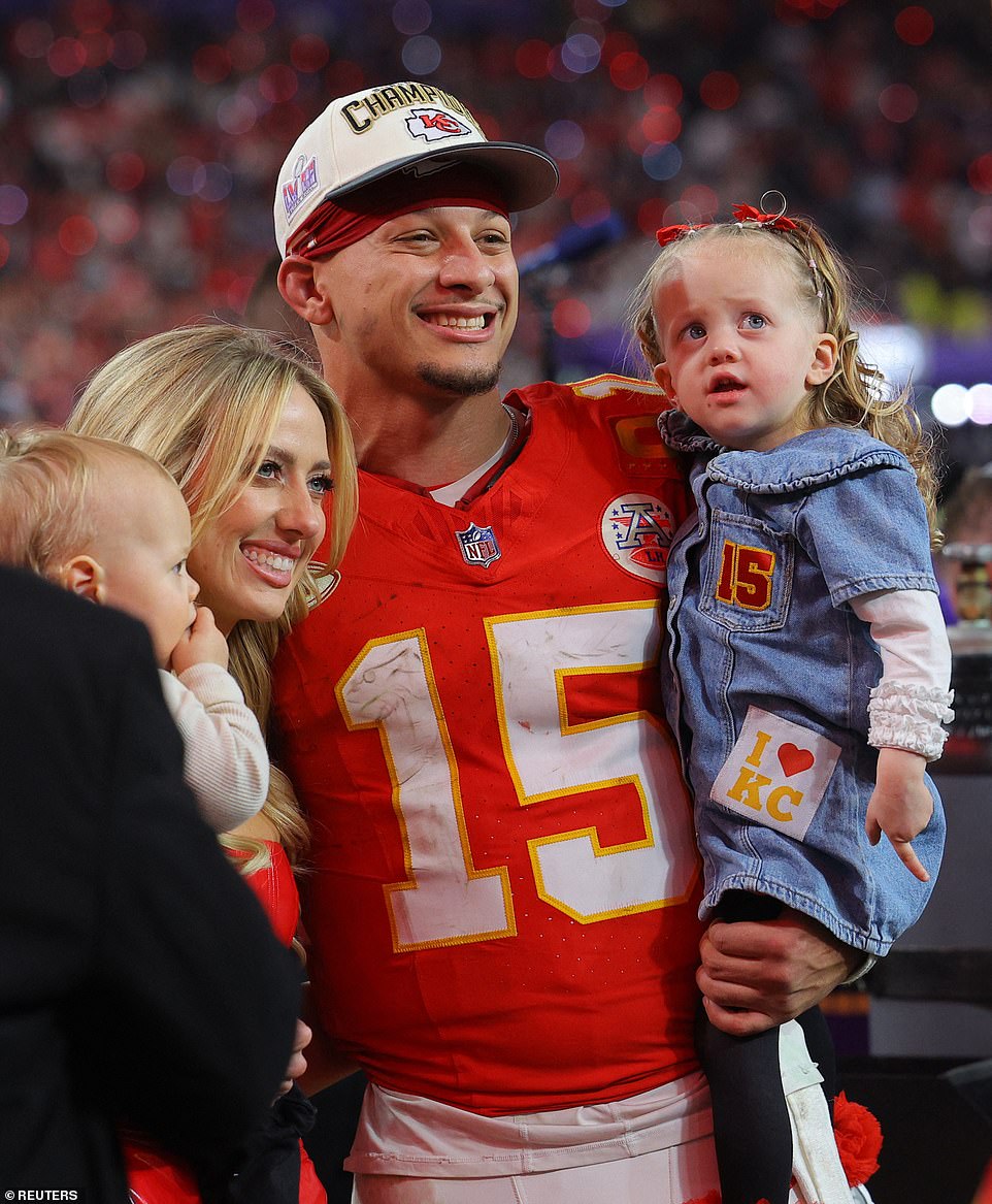 Brittany and Patrick with Sterling and Brons on the field after the big victory