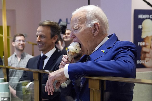 President Joe Biden (right) eats a mint chocolate ice cream cone at Van Leeuwan Ice Cream in New York with comedian Seth Meyers (left)