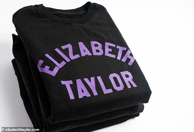 The black sweatshirt simply features Elilzabeth Taylor in purple lettering across the front of the item.