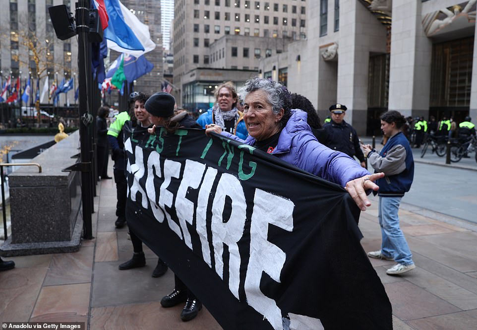 Pro-Palestinian protesters take over the lobby of NBC's Rockefeller Center, where US President Joe Biden will appear for 'Late Night with Seth Meyers' in New York