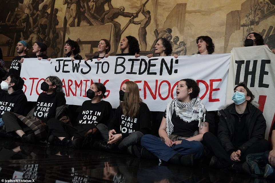 Protesters took over the lobby of 30 Rock on Monday as President Joe Biden was upstairs taping an episode of Late Night with Seth Meyers