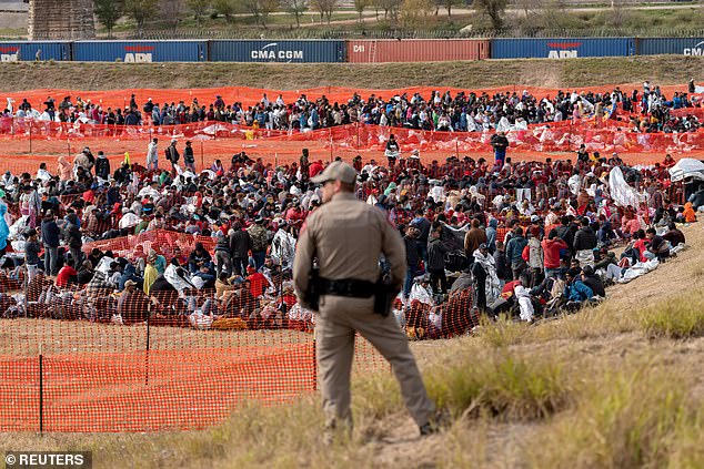 Border Patrol monitors an outdoor processing center in Eagle Pass, Texas, U.S., December 20, 2023