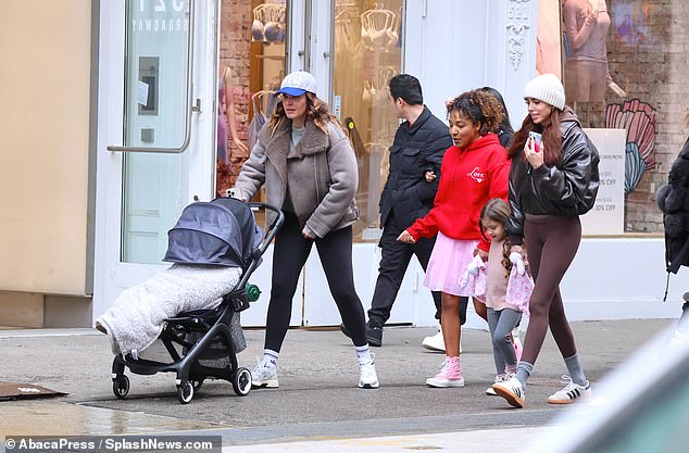 The socialites were accompanied by their young children, pushing strollers and holding hands with their older children