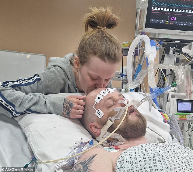 His loved ones, including Mrs Holmes (pictured kissing Mr Wilson) were told nine times by medics that he would not make it over the course of his five-week coma.