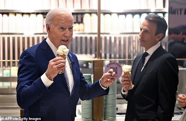 US President Joe Biden speaks to the press with Seth Meyers while they enjoy an ice cream