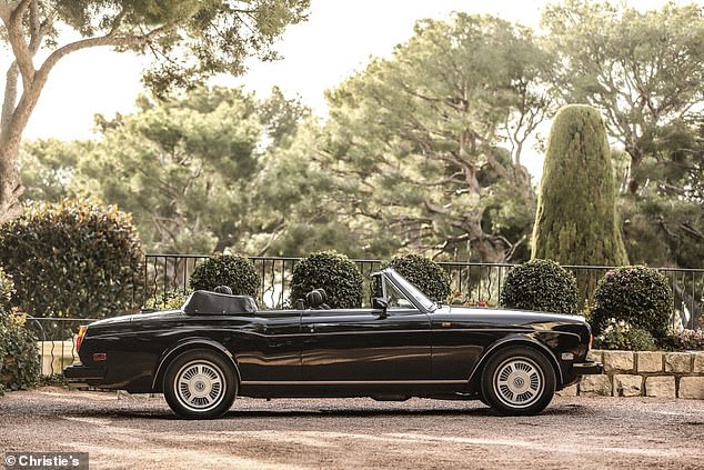 Finished in stunning black paint with a black leather interior and matching black soft-top roof, it features a 6.75-litre V8 engine under the extended bonnet – and a print on the driver's seat of perhaps one of Britain's most respected artists of modern times.  era