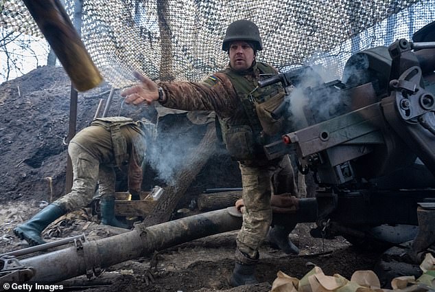 Ukrainian gunman Vasyl Zozulia removes a smoking shell casing after firing the gun