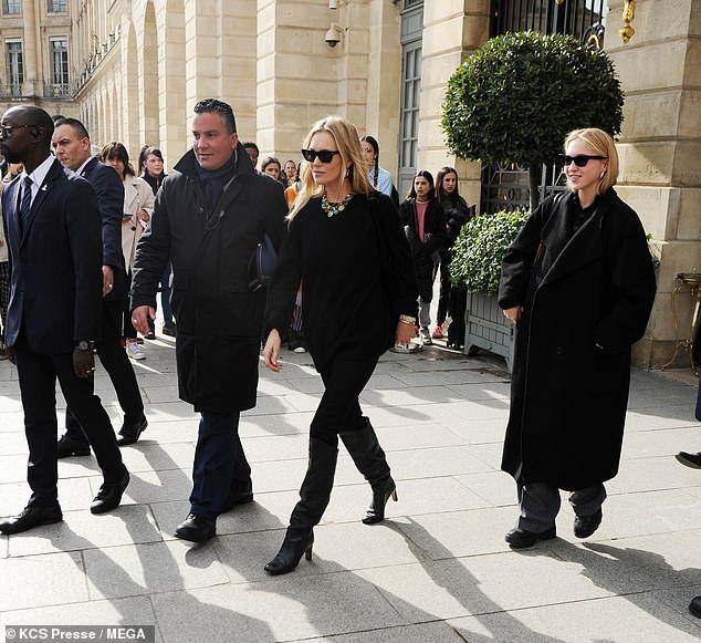 Lila, 21, dressed warmly for the outing in a black trench coat which she wore over a dark top and gray pants