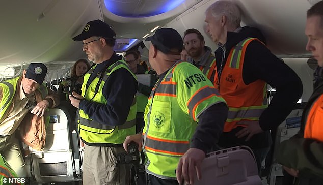 NTSB investigators are seen in the cabin conducting their inspection after the 737 Max 9 was grounded