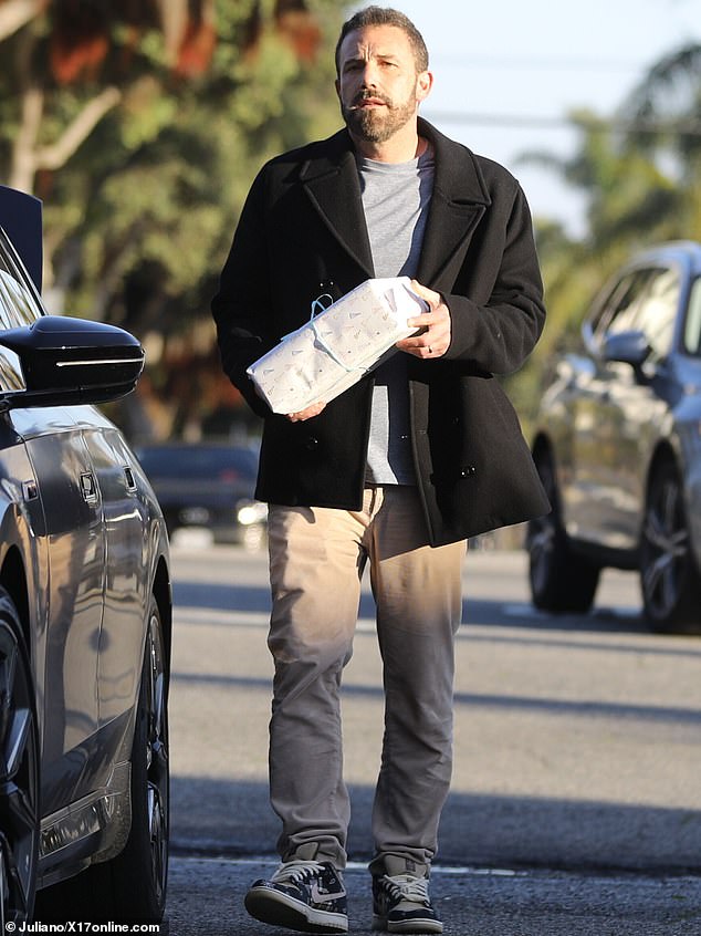 Ben had arrived with a wrapped gift for Samuel, which he balanced on one forearm while carrying a water bottle in his hand