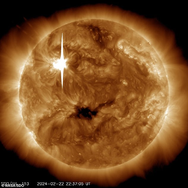 NASA's Solar Dynamics Observatory captured this image of the X6.3 solar flare (as seen in the bright flash at upper left) on February 22, 2024.  The image shows a subset of extreme ultraviolet light that highlights the extremely hot material in the solar flares.  which is colored in bronze