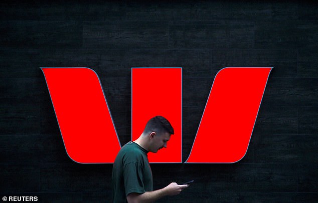 “From time to time we change the way we work and this may impact some roles and responsibilities,” a Westpac spokesperson said.  A man is shown walking past a Westpac sign