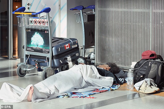 A passenger sleeps on the floor at Ministro Pistarini International Airport in Ezeiza, Argentina, on Wednesday after flights were canceled due to a 24-hour strike by workers.  Three unions representing workers rejected a 12 percent pay increase offered last week