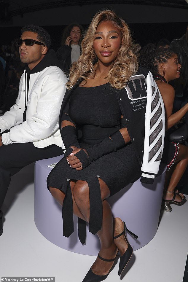 Serena cut a stylish figure in a baseball jacket which she wore under a stretchy black cut-out dress