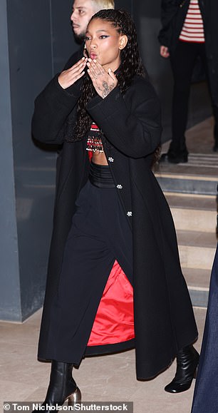 Willow looked stylish in a black coat and red-striped crop top as she walked to the venue