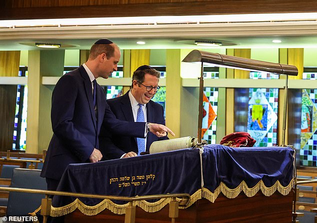 Rabbi Daniel Epstein shows Britain's Prince William a 17th century Torah scroll as he visits the Western Marble Arch Synagogue