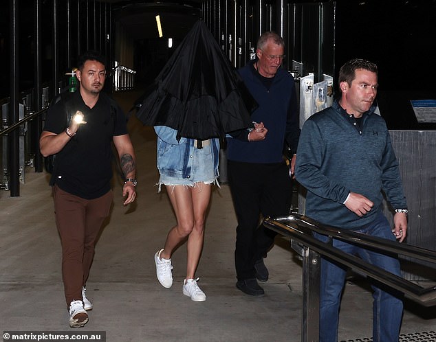 Her departure comes just hours after her father Scott (center right), 71, was accused of punching photographer Ben McDonald, 51, in Australia about 2:30 a.m. on Tuesday.