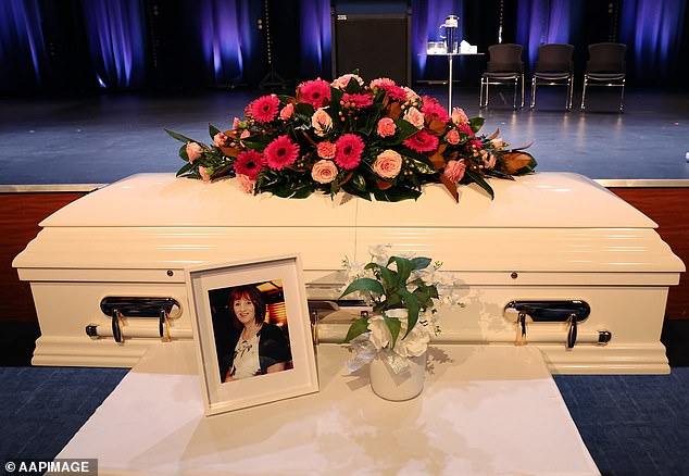 Mrs White's coffin (pictured) was decorated with roses and gerberas and a portrait of the beloved grandmother rested in front of it