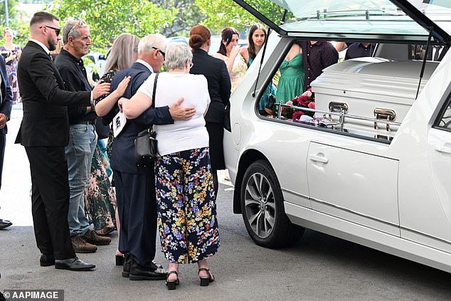 There were emotional scenes outside the church after Mrs White's funeral service as friends and family consoled each other (pictured)