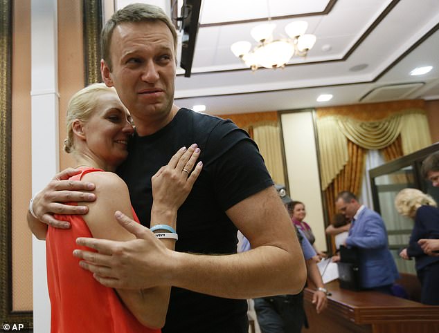 Russian opposition leader Alexei Navalny, right, hugs his wife Yulia as he was released by a court in Kirov, Russia, July 19, 2013