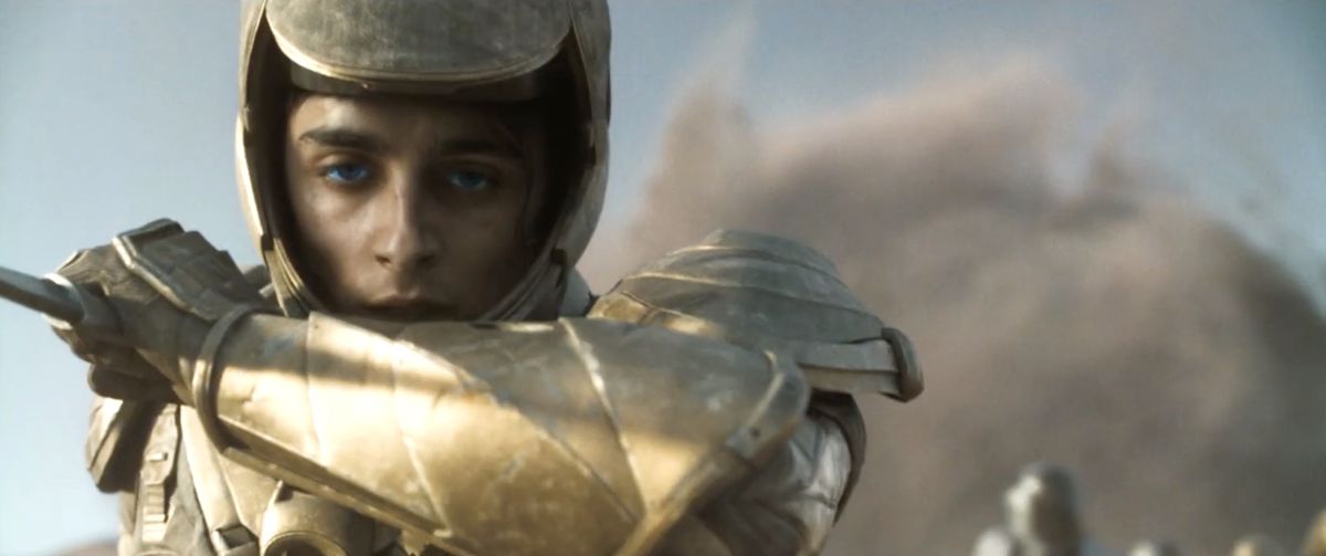 a close-up of Paul (Timothee Chalamet) wearing gold armor in Dune