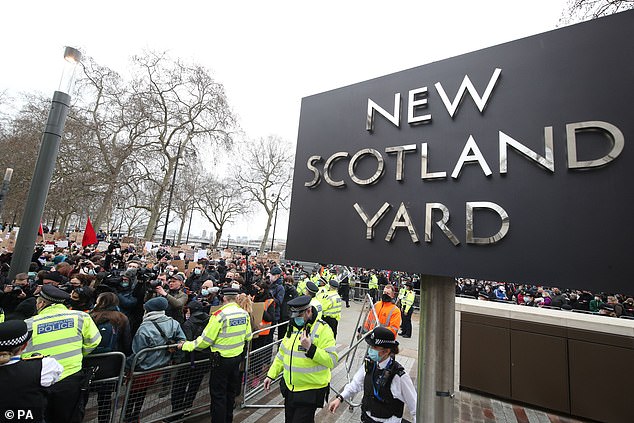 A crowd gathers for a vigil in Sarah's memory outside New Scotland Yard on March 14, 2021