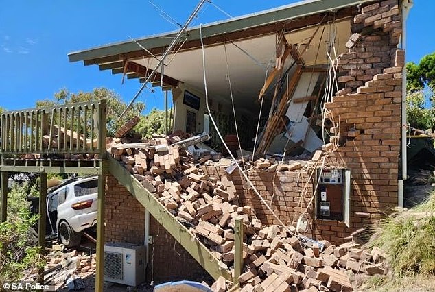 A driver who forgot to apply the handbrake on his car led to the destruction of a house after the vehicle drove through the property (pictured)