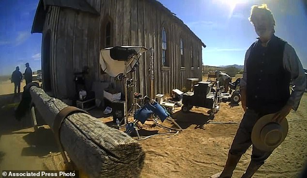 In this undated image from a video released by the Santa Fe County Sheriff's Office, Alec Baldwin speaks with investigators after a fatal shooting on a film set in Santa Fe.