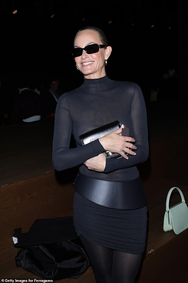 Amber Valletta playfully tried to cover up her modesty at the Ferragamo show during Milan Fashion Week on Saturday