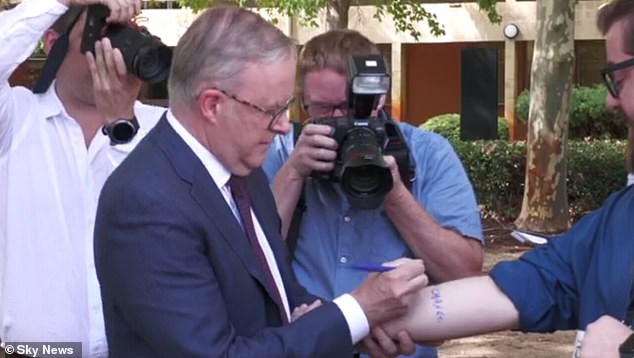 Anthony Albanese caused a stir at a press conference on Monday when he signed a journalist's arm pledging not to change Western Australia's GST allocation