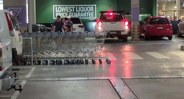 A photo shared on social media shows a row of ALDI shopping carts chained together in an assigned spot.  However, the line is so long that it extends and blocks half of the road in the parking garage.