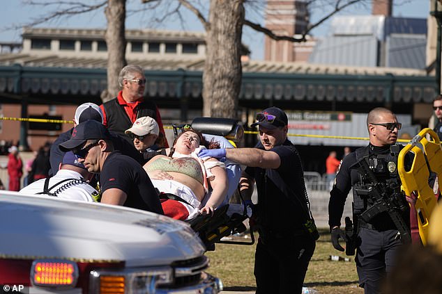 A woman was seen being carried away from the scene with a large cut on her face