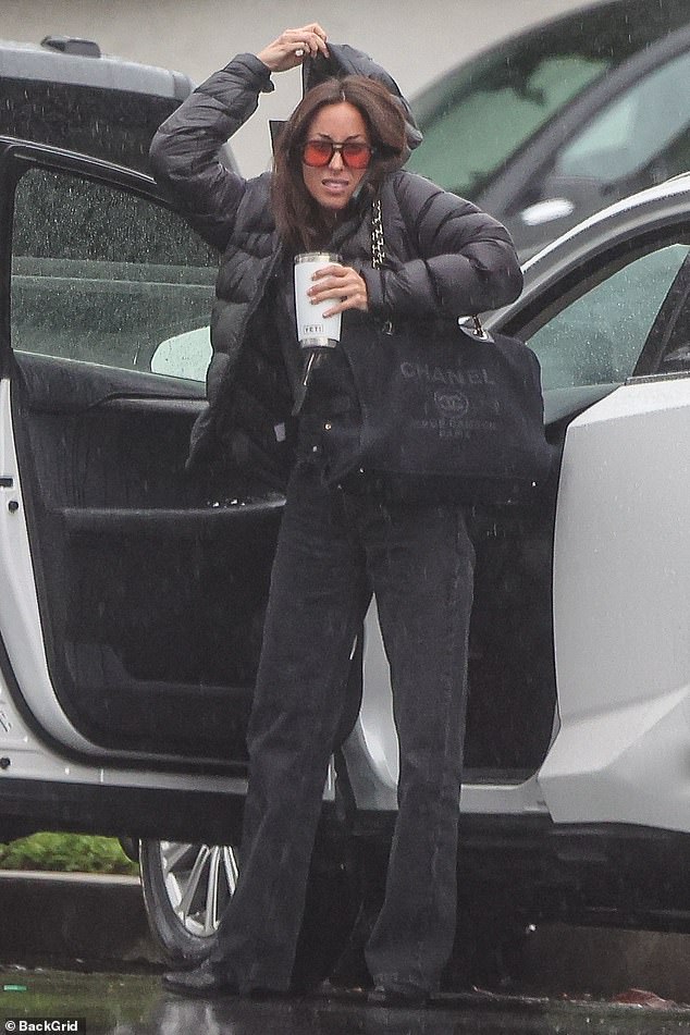 Brad Pitt's girlfriend Ines de Ramon, 34, was pictured braving the rain in Los Angeles on Tuesday after the actor, 60, was accused of 'volatile' behavior by his former director