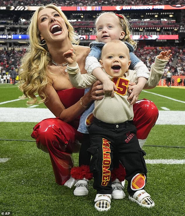 Brittany went to the field and took pictures next to her two children