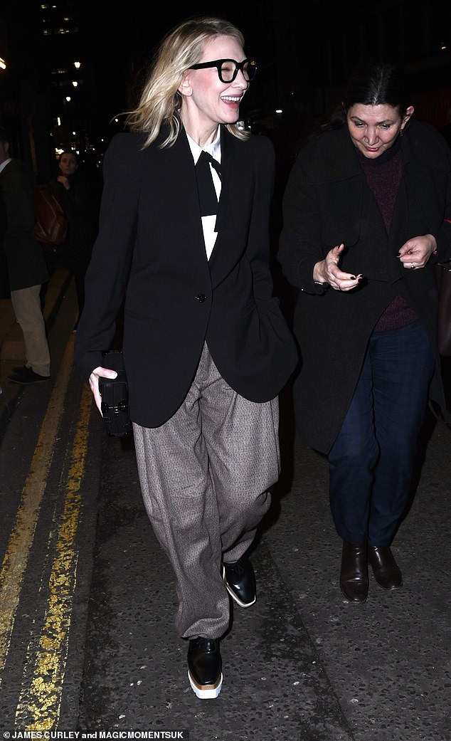 The actress, 54, wore crazy glasses and a sloppy suit as she attended the show at The Duke of York Theatre