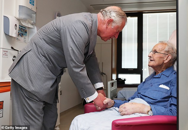 Charles meets Robert Mawhinney during a tour of the North West Cancer Center at Altnagelvin Hospital in Londonderry during a visit to Northern Ireland on May 9, 2017