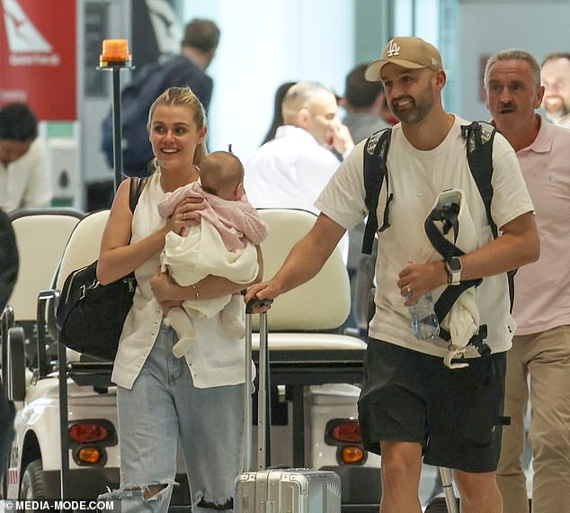 Cricketer Nathan Lyon and his wife Emma were one big, happy family when they landed in Sydney on Monday