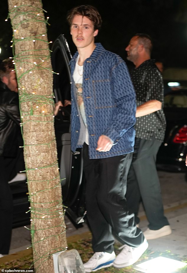 Cruz Beckham wore a T-shirt with a photo of one of his iconic childhood moments as he dined at Papi Steak with father David in Miami on Thursday