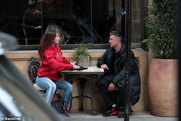 Jemma looked casual in a red hoodie and flared ripped jeans which she teamed with a crossbody bag and black trainers