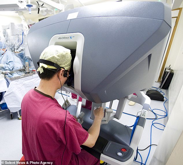 Doctors who perform the operation using the robot operate the arms from behind a console