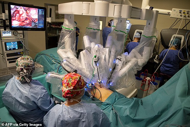 The da Vinci robot is a free-standing cart equipped with four arms.  One arm holds a camera or laparoscope and the surgeon controls the other three 'hands' by inserting their fingers into small sets of loops