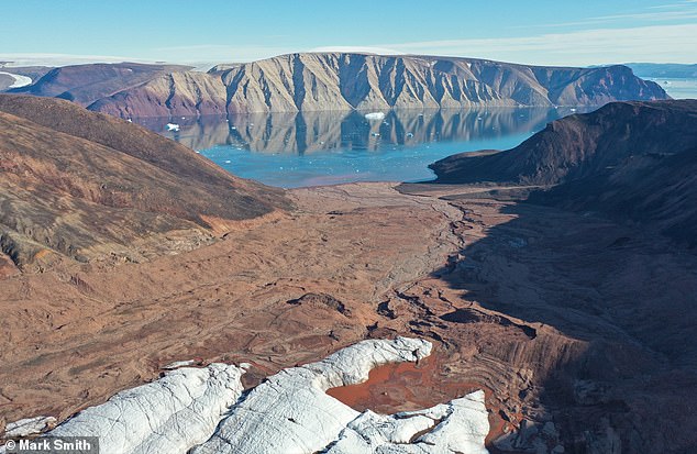 An estimated 11,000 square kilometers of Greenland's ice sheet and glaciers have melted over the past thirty years, according to an extensive analysis of historical satellite data.  Pictured, exposed land from above Sydgletscher looking towards Bowdoin Fjord, in Qaanaaq, northwestern Greenland