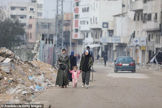 Palestinians return to their neighborhood after Israeli forces withdrew from Shuja'iyya neighborhood, inspecting destroyed buildings and roads due to Israeli attacks in Gaza City, Gaza on Tuesday