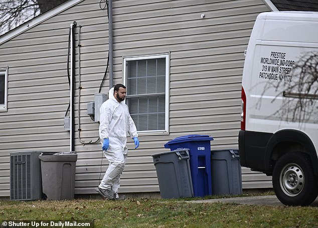 Exclusive photos from DailyMail.com show members of a private biohazard cleanup team entering the Levittown property, two days after Michael Mohn's body was discovered in the bathroom